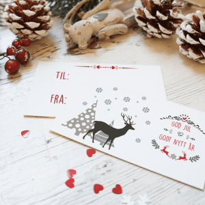 Julekort reinsdyr - To eksempel på forside og bakside Motiv av reinsdyr, juletre og snø - God jul og godt nyttår